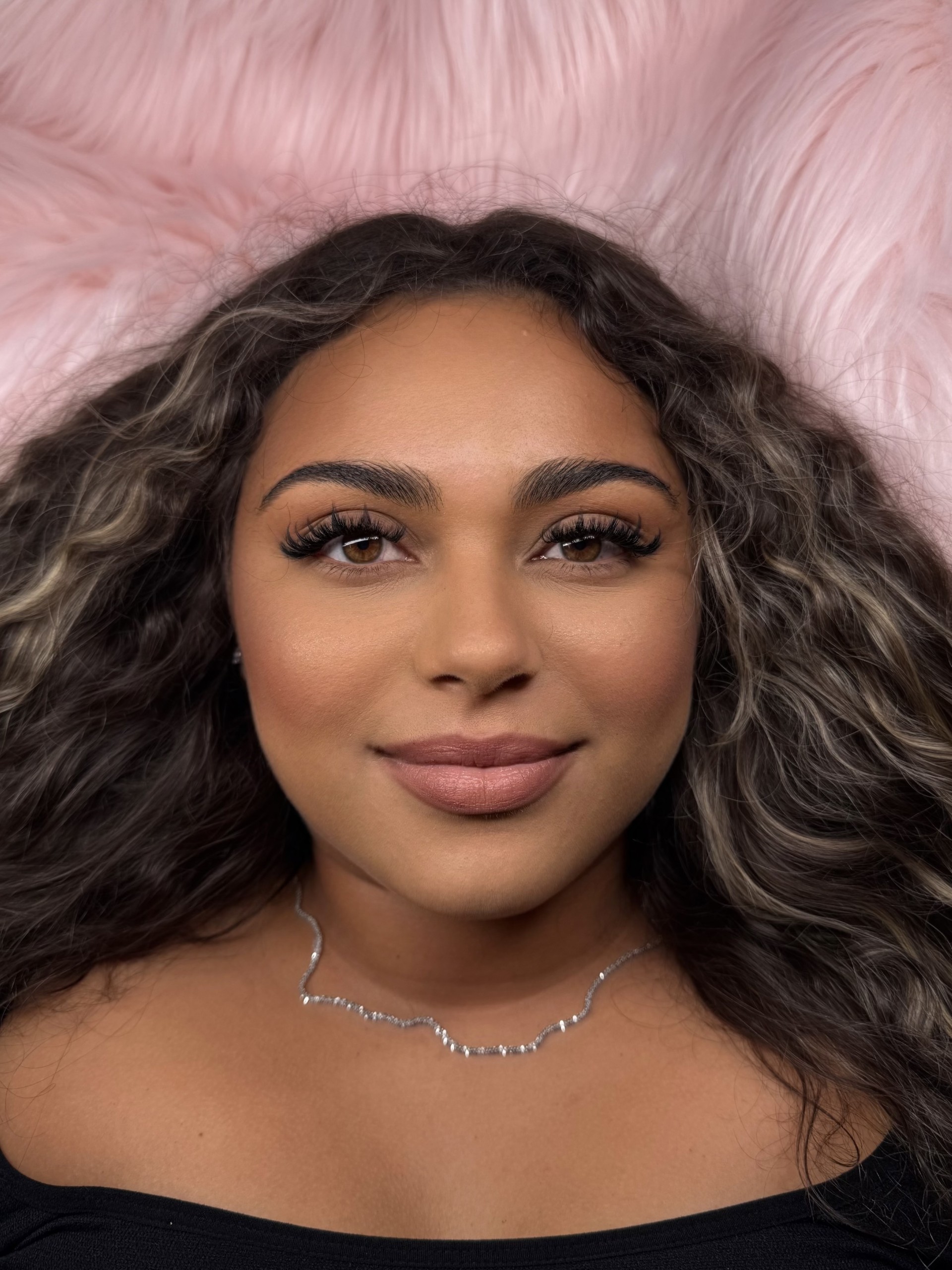 Anime-style lash extensions on curly-haired client